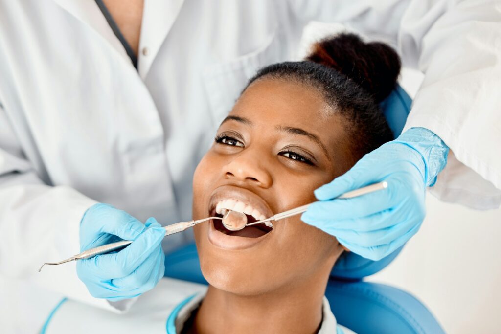 Dentist checking female patient's oral health during examination, emphasizing the importance of dental care.