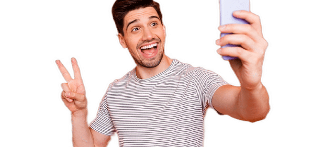 Man taking a selfie after following Plaque Removal at Home procedures recommended by Wells Family Dental